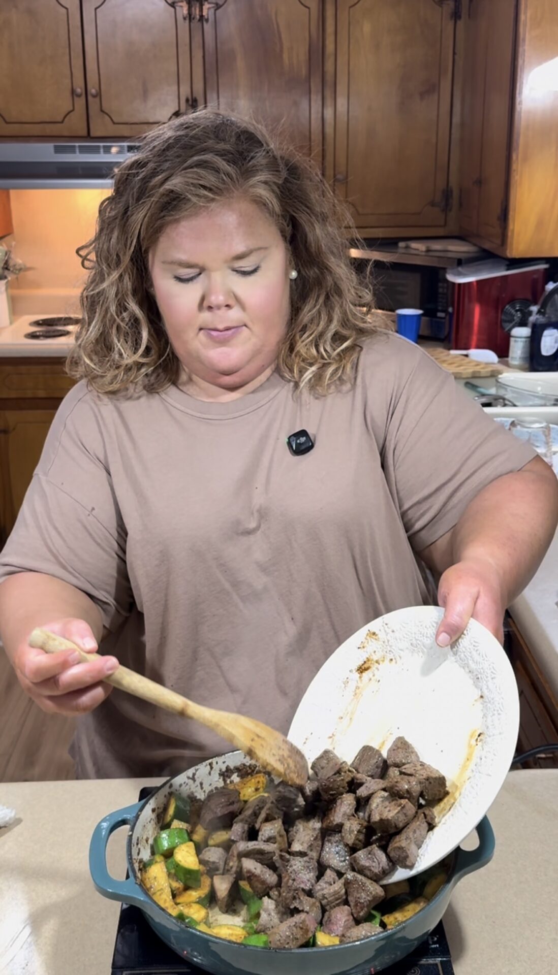 A woman holding a plate of food.