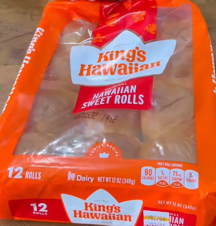 A package of Kings Hawaiian Sweet Rolls, containing 12 rolls in an orange and clear plastic bag, showing nutritional info and the brand logo on the front.
