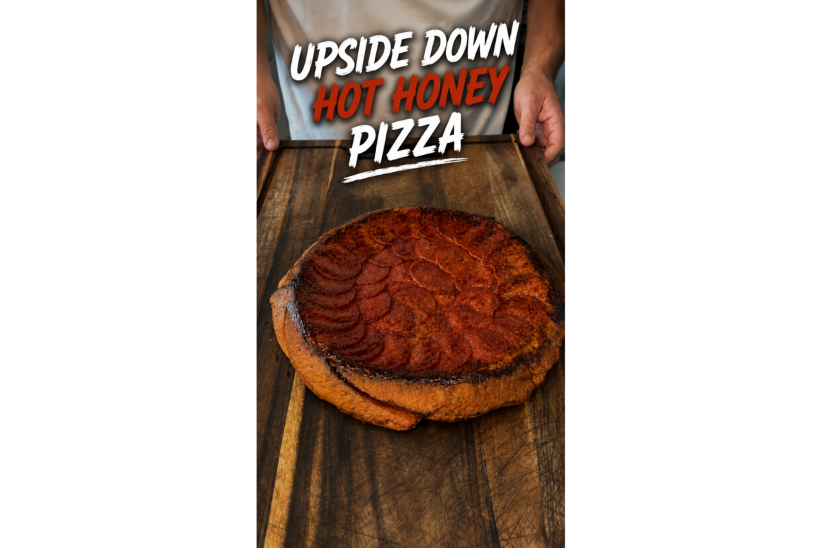 A person holds a wooden board with an upside-down hot honey pizza topped with pepperoni; text above reads Upside Down Hot Honey Pizza..