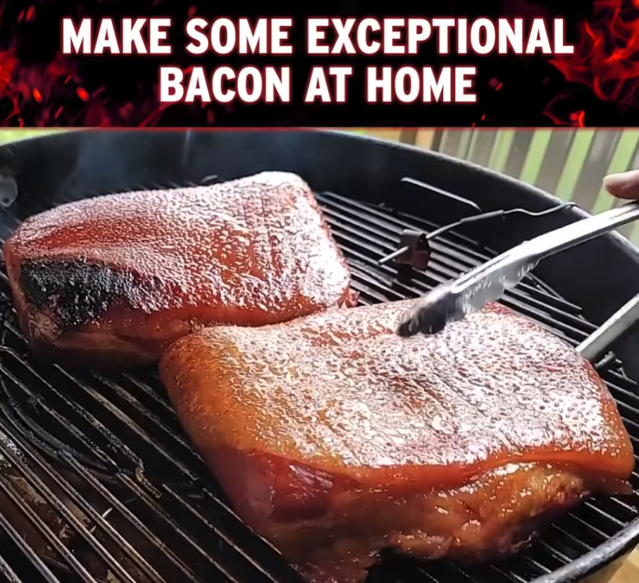 Two slabs of bacon cooking on a grill with metal tongs. White text above reads, MAKE SOME EXCEPTIONAL BACON AT HOME, on a black and red background. Steam rises from the sizzling bacon.