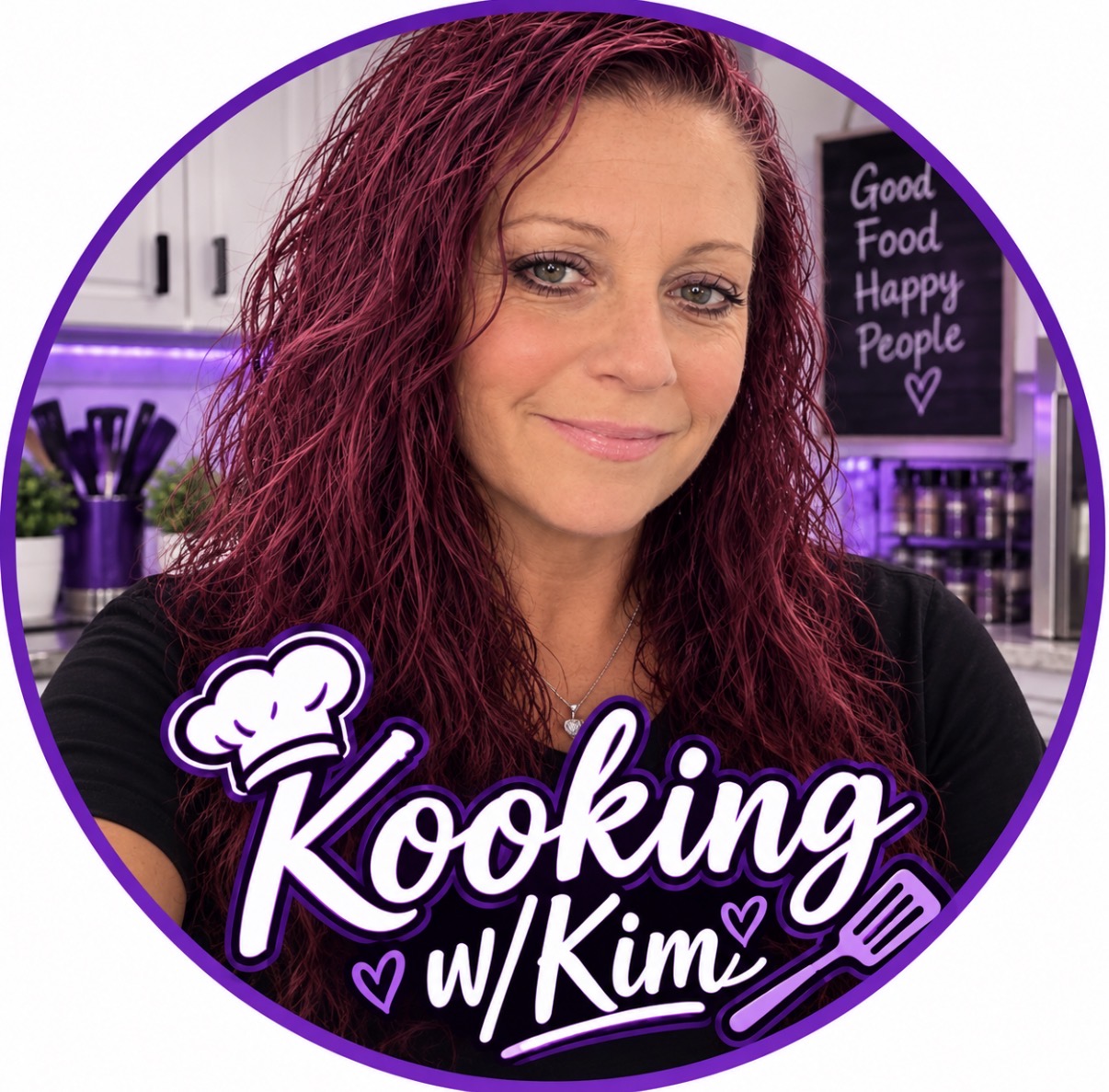 A woman with long, wavy dark red hair smiles in a kitchen with purple accents. A chalkboard behind her reads Good Food Happy People. Text on the image says Kooking w/ Kimi with a chef hat and utensils.
