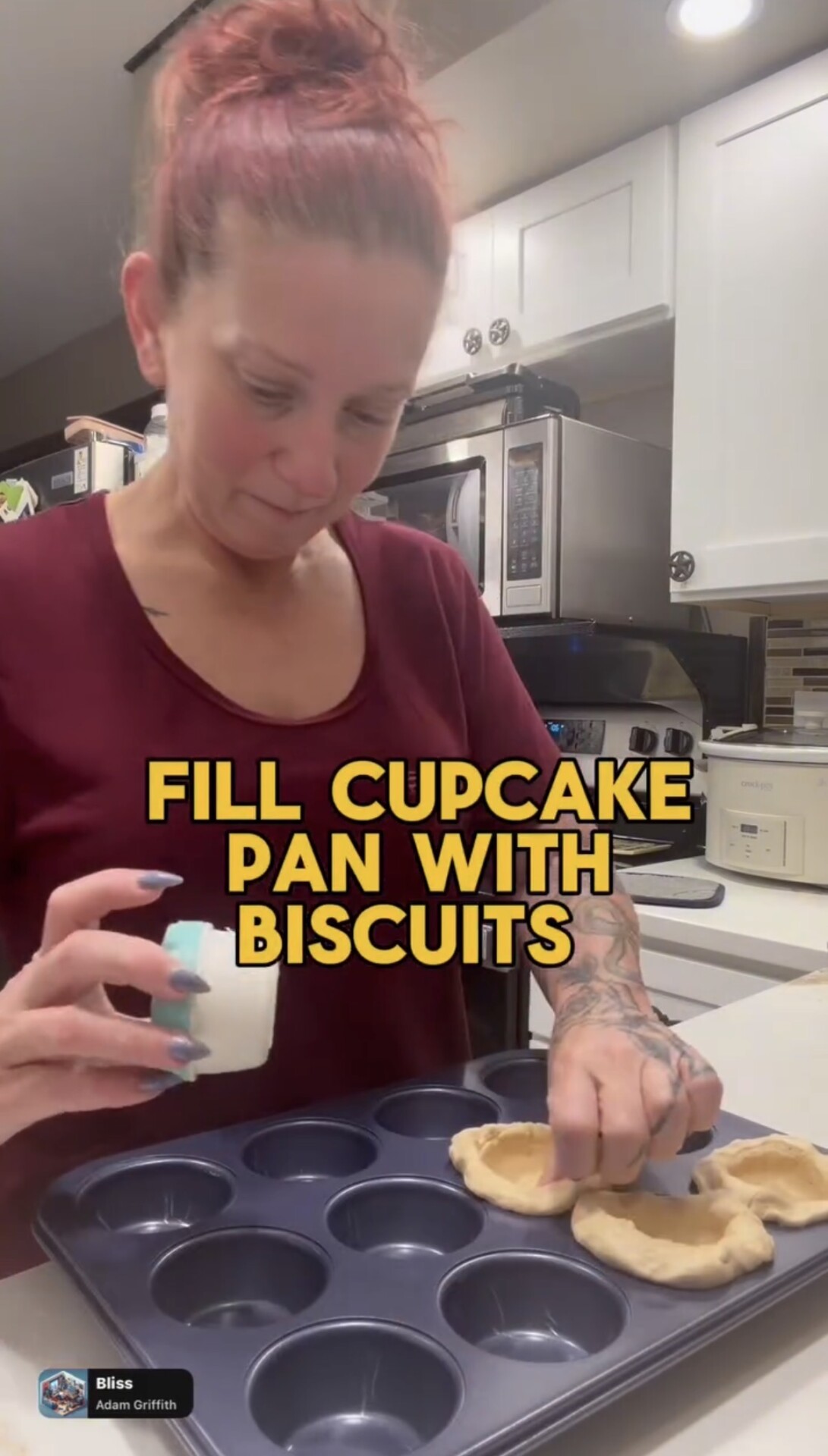 A woman placing rounds of biscuit dough into the cups of a muffin pan, with the text FILL CUPCAKE PAN WITH BISCUITS overlaid.