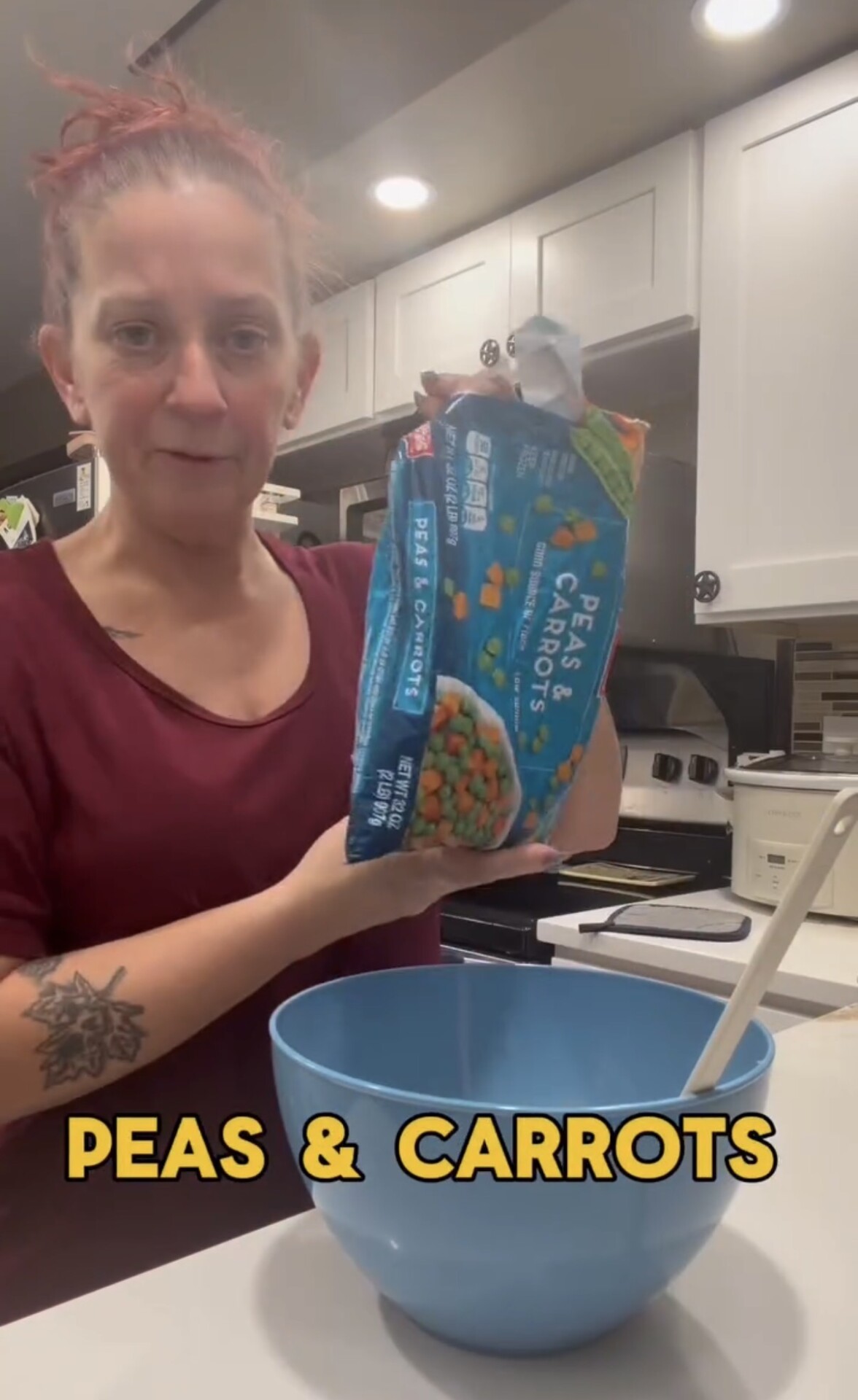 A person holds a bag of frozen peas and carrots above a blue mixing bowl, with the text PEAS & CARROTS at the bottom of the image.