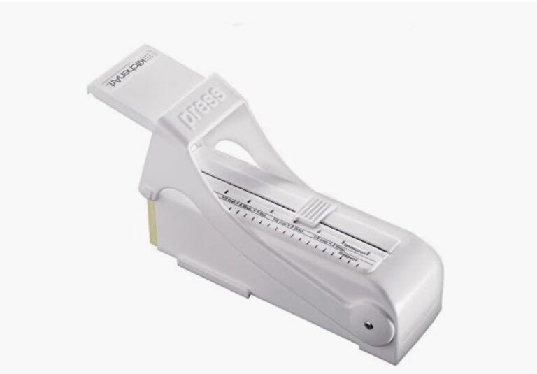 White KitchenArt adjustable measuring tool with a sliding selector and printed volume markings.